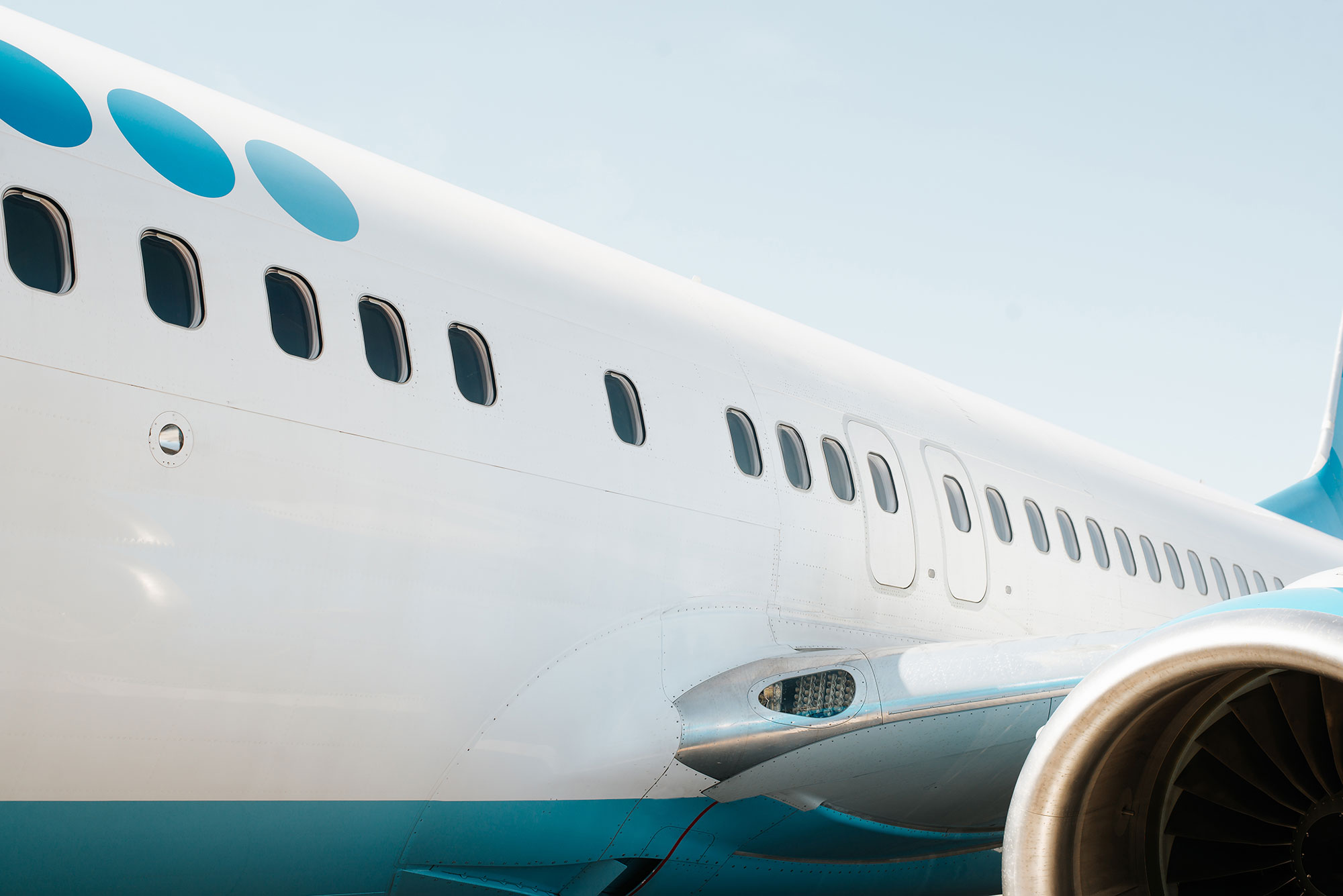 Close-up of an airplane on the runway row of wind